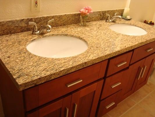 bathroom remodel with slab granite counters and tile floor