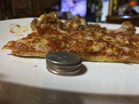 Pizza about four 25 cent quarter pieces thick with no extra cheese