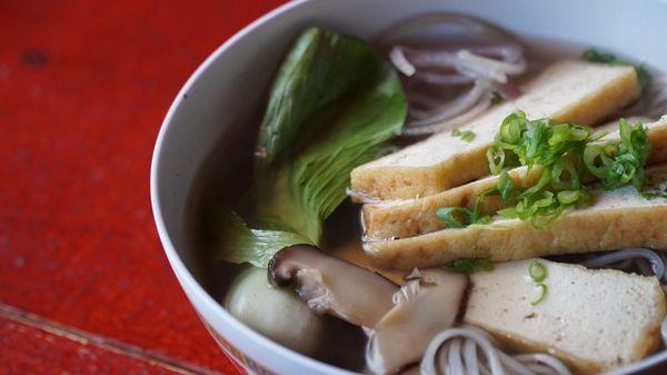 Vegan pho (Vietnamese noodle soup) with tofu, bok choy, shiitake mushrooms, & a side of bean sprouts, basil, lime, & jalapenos. Gluten-free