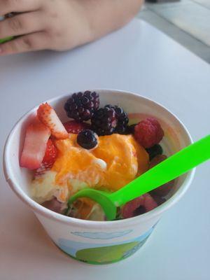 Orange,  mango, and strawberry with fruit toppings.