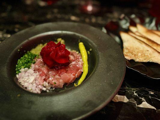 TUNA TARTARE bluefin tuna, ginger, capers, cornichons, onion, toasted pan