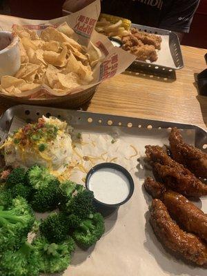 Salsa and chips, chicken crispers, honey chipotle chicken crispers, loaded mashed potatoes, broccoli, corn, and fries