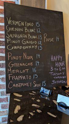 The current wine selection on a blackboard.