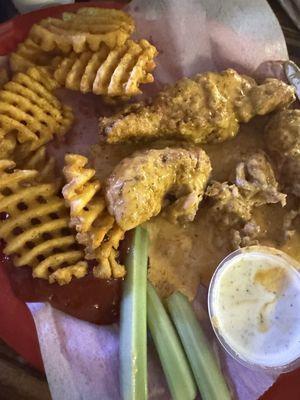 Chicken tenders tossed in Cajun ranch with waffle fries