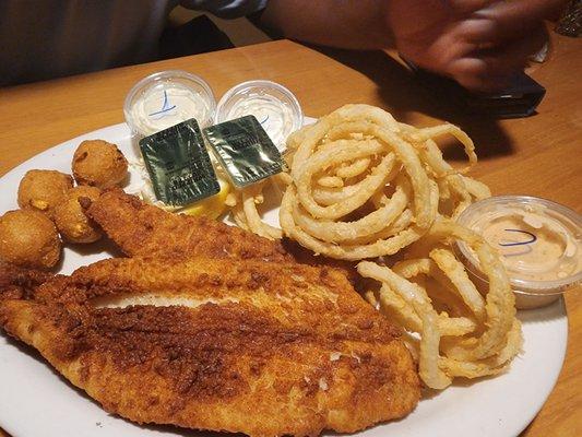 Fried grouper with onion rings and hush puppies. (The Seafood Dinner)