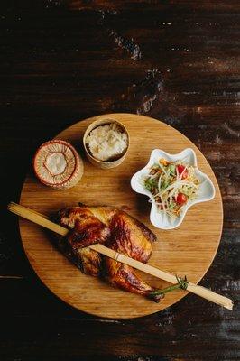 Kai Yang - Grilled marinated half chicken served with papaya salad and sticky rice