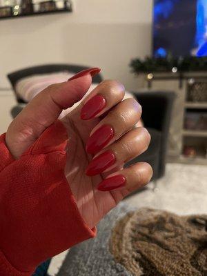 red dipping powder nails with extensions in the almond shape