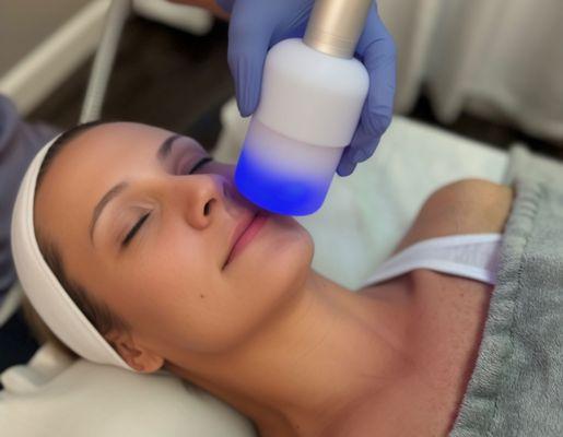 Gorgeous client receiving a cryo glow facial for skin tightening and toning.