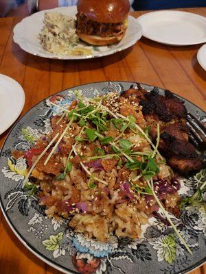 Rice bowl with pulled pork sandwich beyond.