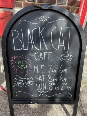 SIgn with hours for the newly reopened Cat