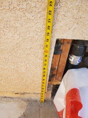 Stucco wall and part of foundation removed during prior plumbing repair.