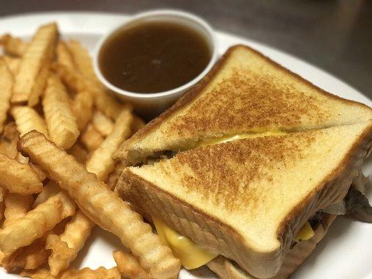 Patty melt on grilled Texas toast layered with cheese, sautéed onions, mushrooms, & a side of homemade brown gravy.