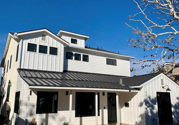 Beautiful home with charcoal gray standing seam roof