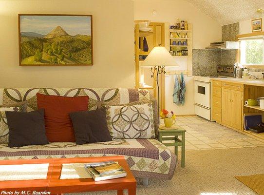 Living room and view into the kitchen inside the Hollyhock Guest House