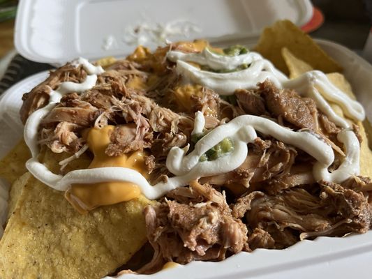 Nachos with chicken, sour cream, and guac