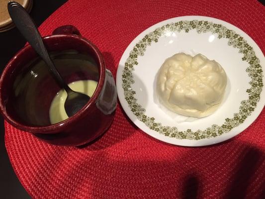 Matcha latte and a steamed bun with red bean paste.