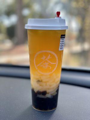 Passion fruit green tea with boba and lychee jelly