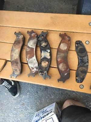 Used brake pads that they told us were new and the ones that burnt up from the caliper seizing from being installed incorrectly