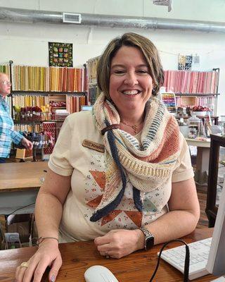 One of the amazing staff showing her shawl with a ruler bracelet used as a clasp.