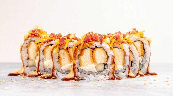 This is our Chik-Roll-A Roll. Chicken Tempura, cream cheese and cucumber inside, topped with melted cheese and bacon.