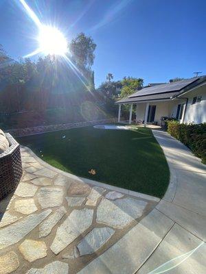 A flagstone patio with some artificial grass always goes well together!