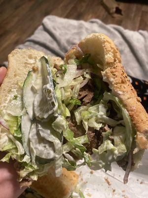 Steak and cheese with extra lettuce, cucumber and onion