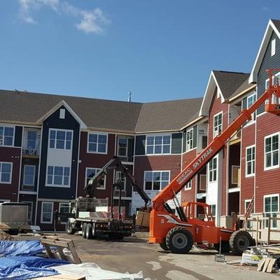 Fiber cement siding installation nearing completion on this side of the building.