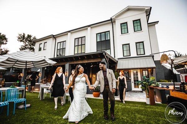 The happy couple featuring bride in custom A Plus Curves Bridal