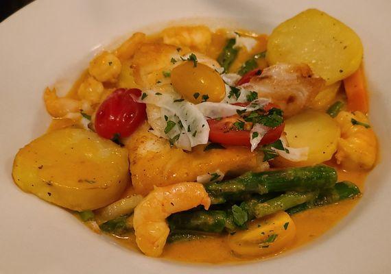 Cod filets finished in crayfish sauce w/ shrimp, potatoes fondant, asparagus, & tomatoes.