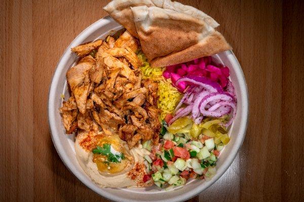 CHICKEN SHAWARMA BOWL
 
 Basmati yellow rice, mid-east pickles, tomato and cucumber salad medley, purple cabbage, dollop of fresh hummus