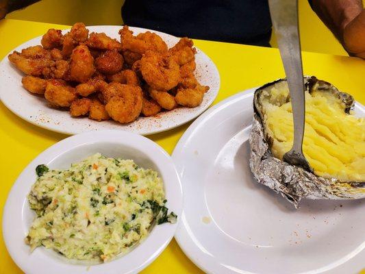 Shrimp dinner (bang bang and cajun shrimp) with slaw and baked potato.