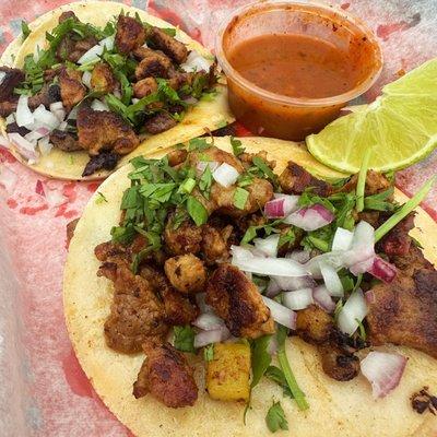 Tacos al pastor/carne asada with salsa roja.