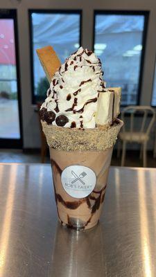 Crazy Coffee Specialty Shake: Coffee base dressed with a slice of Cheesecake, a Biscotti, & Espresso Beans