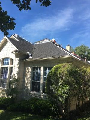 Production photos of full roof replacement in Austin.