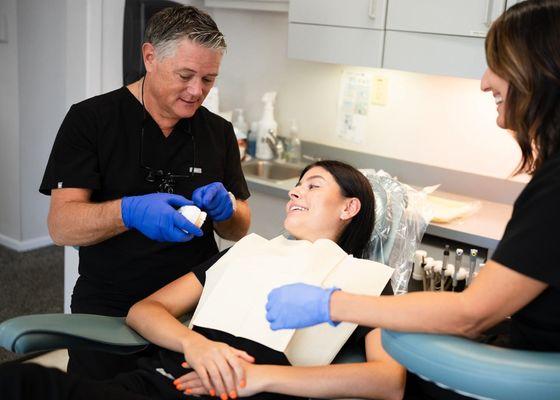 Dr Campbell educating patient with a model. Visual is a great way to explain dental procedures.