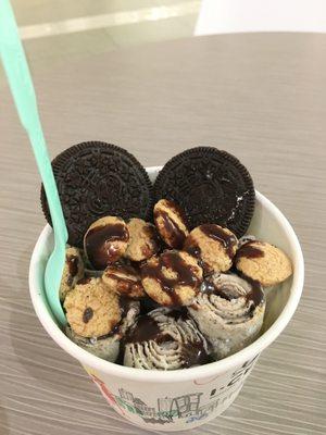 Cookie's and Cream, topped with chocolate syrup, two Oreos, and Captain Crunch like bits.