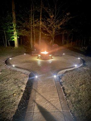 Stamped concrete patio with custom made fire pit and LED's in the colored border and under fire pit cap