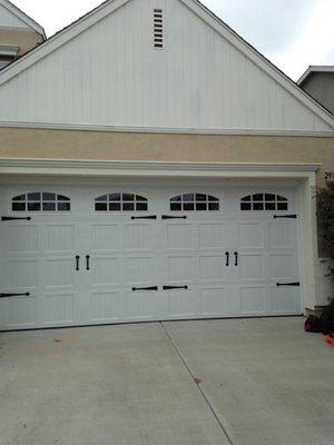 white carriage house style with windows and decorative hardware