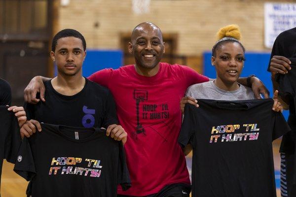 Hoop 'Til It Hurts founder Michael Horton with a couple of his students showing off their new Hoop Ts.