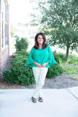 Green top with faux leather pants