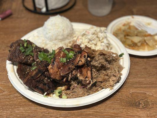 The Hungry Hawaiian plate with Beef Short Ribs, teriyaki chicken, pulled pork, sticky rice, macaroni salad, and Steamed Cabbage.