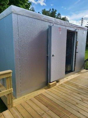 Walk-in freezer installation on a raised deck.