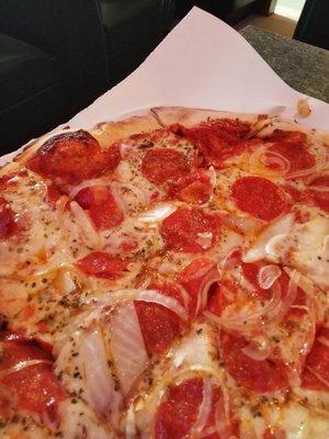 Pepperoni and onion thin crust pizza.