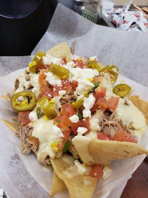 Pork carnitas nachos with queso fresco, pico de gallo, and pickled jalapenos