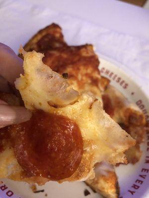 Not fresh pizza, hard, translucent cheese. Burnt crust.