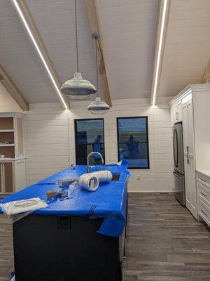 Custom strip lighting in traditional beach bungalow.