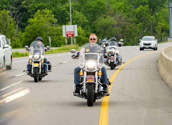 The Biker Lawyers riding motorcycles down a highway