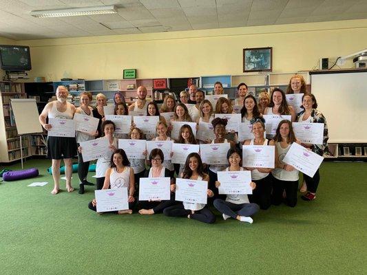 Amber at Graduation with her yoga certification and fellow yogis