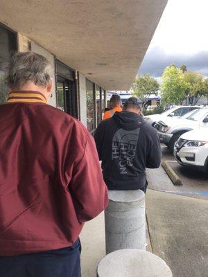 Line outside because a ten customer limit inside store was enforced this day.