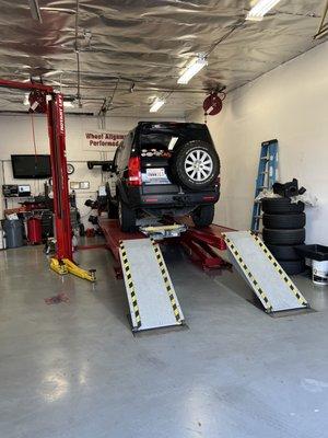 Vehicle on alignment rack.